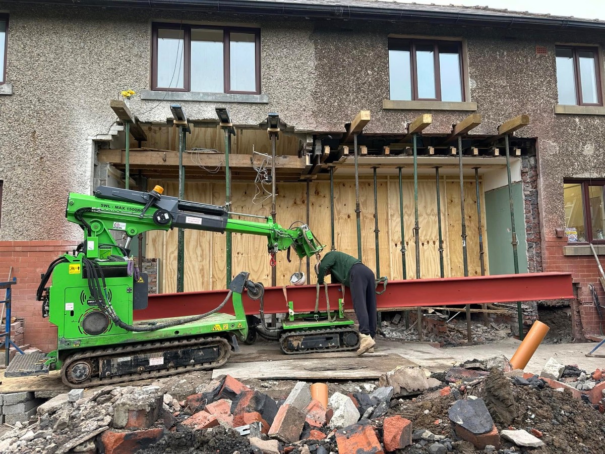 Two-storey extension opening propped with acrows ready for steel beam